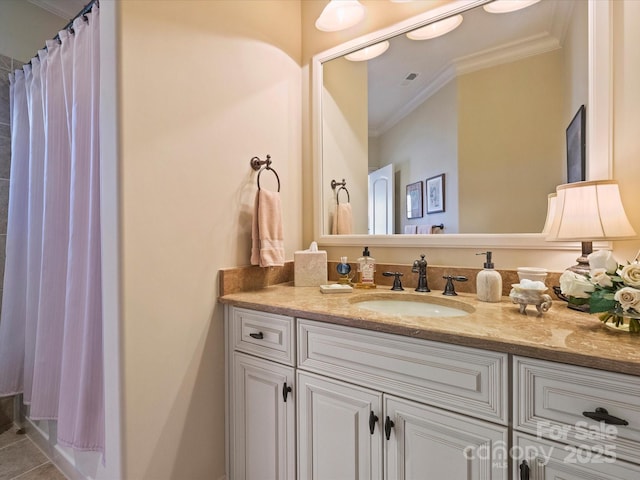 bathroom with vanity, crown molding, and tile patterned flooring