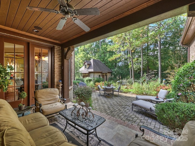 view of patio / terrace with ceiling fan and an outdoor living space