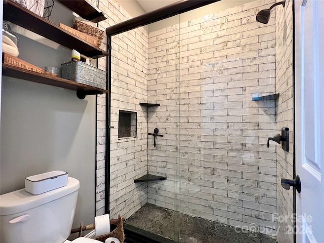 bathroom with a shower with door and toilet