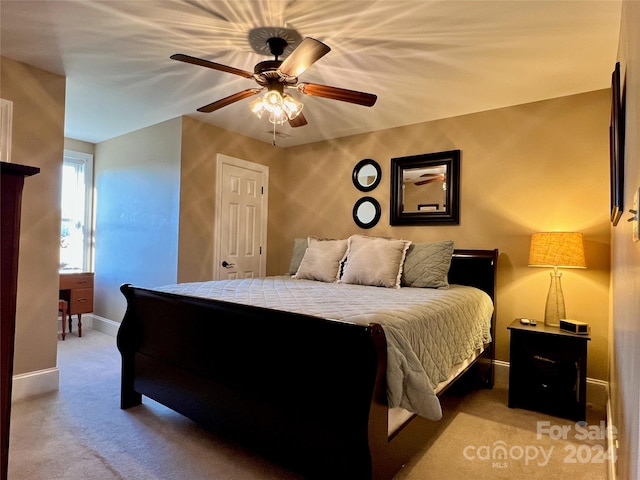 bedroom featuring light colored carpet and ceiling fan