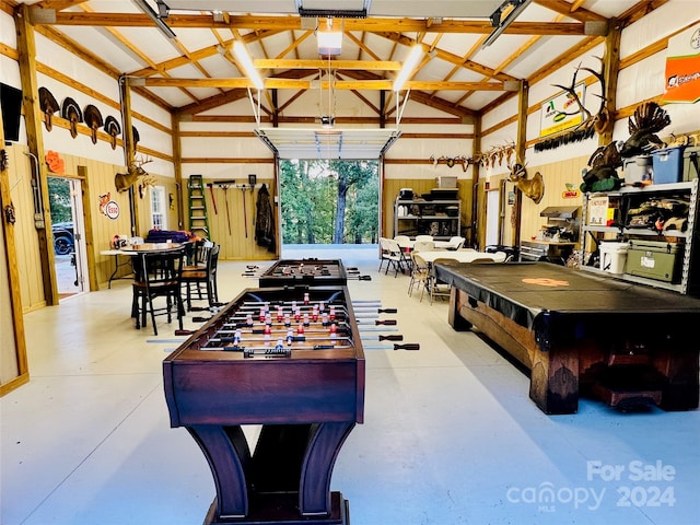 playroom featuring high vaulted ceiling