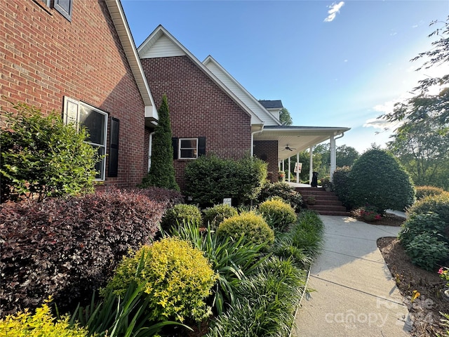 view of side of property featuring covered porch