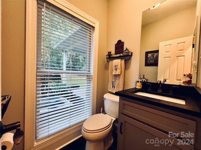 bathroom featuring vanity and toilet