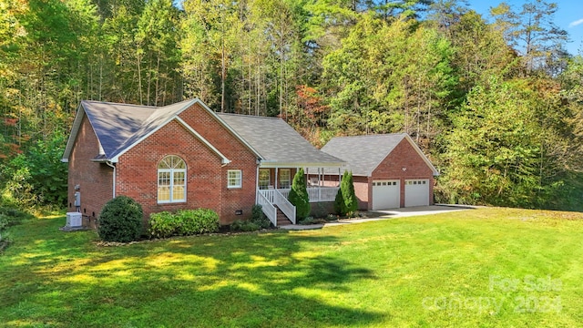 view of front of house with a front yard, a garage, and covered porch