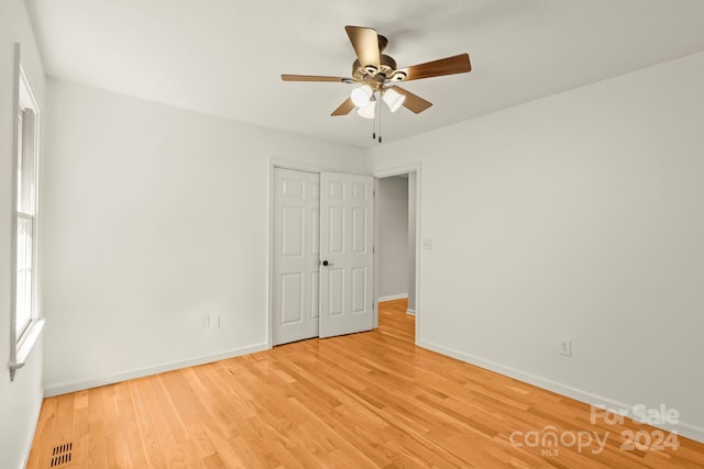 unfurnished bedroom with a closet, ceiling fan, and light hardwood / wood-style flooring