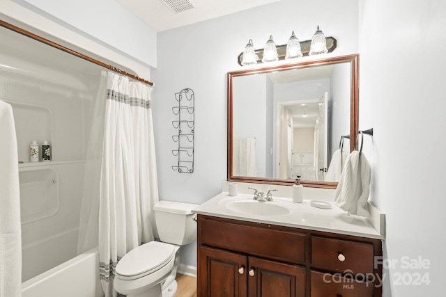 full bathroom with vanity, shower / tub combo with curtain, toilet, and hardwood / wood-style flooring