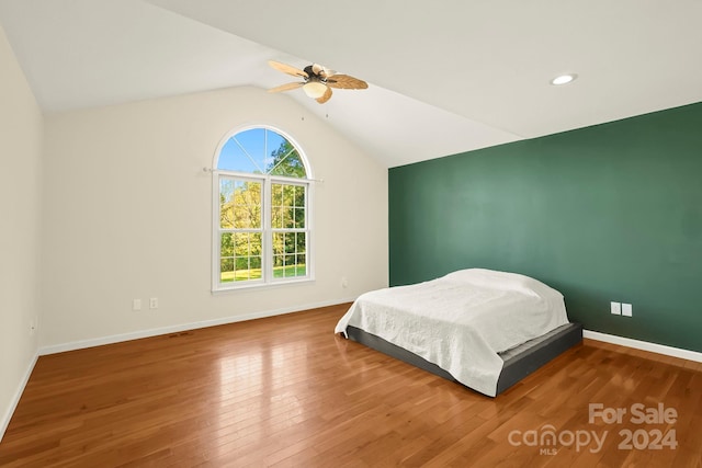 bedroom featuring lofted ceiling, wood-type flooring, and ceiling fan