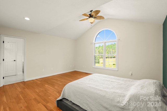 bedroom featuring ceiling fan, vaulted ceiling, and hardwood / wood-style floors