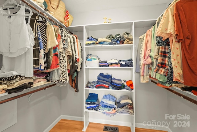 walk in closet featuring light hardwood / wood-style flooring