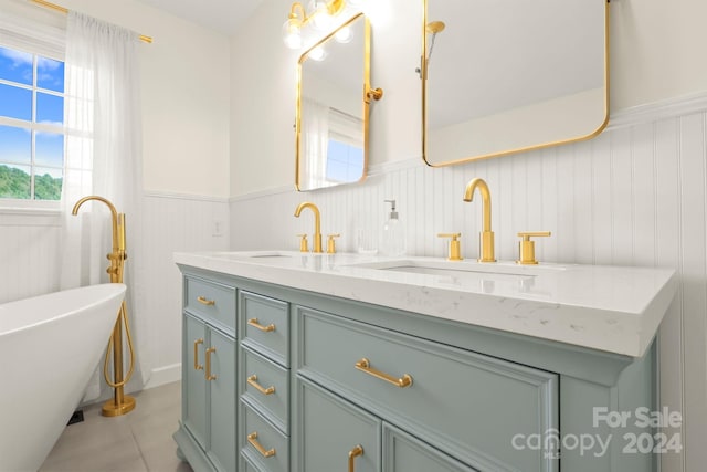 bathroom featuring vanity, a bathtub, and tile patterned flooring