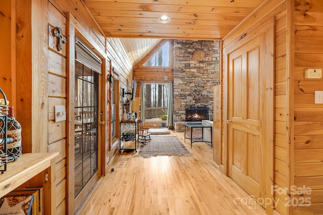 hall featuring wood ceiling, lofted ceiling, and wood-type flooring