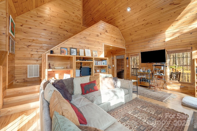 living room with wooden ceiling, wooden walls, visible vents, and high vaulted ceiling