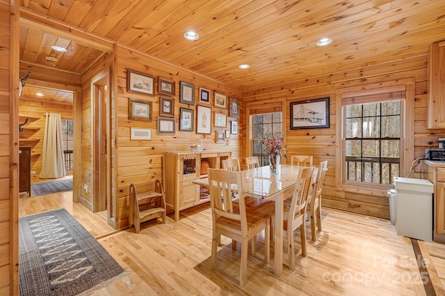 dining area with recessed lighting, light wood-type flooring, wood ceiling, and wood walls