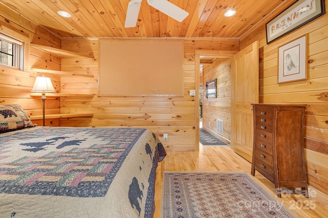bedroom featuring wood finished floors, wood ceiling, and wood walls