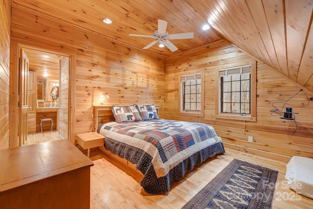bedroom with wooden walls, wood ceiling, lofted ceiling, and hardwood / wood-style floors
