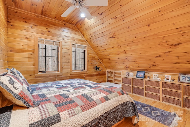 bedroom featuring a ceiling fan, wood finished floors, wooden walls, wooden ceiling, and lofted ceiling