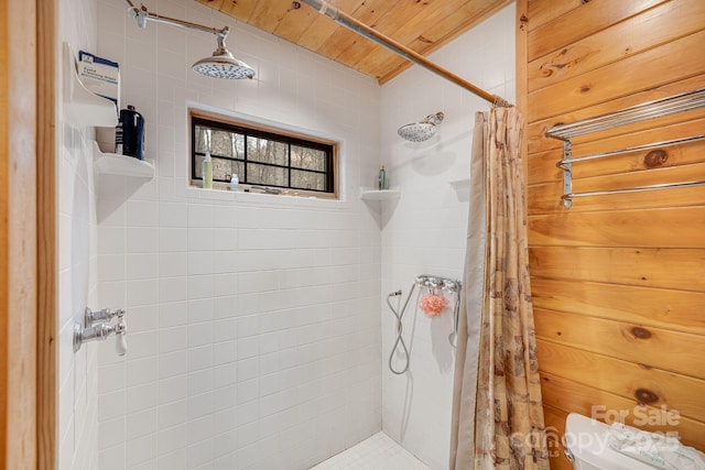 bathroom featuring wood ceiling and a tile shower