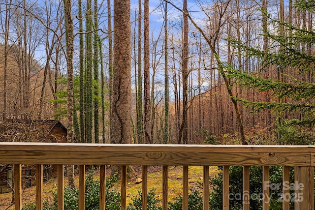 wooden terrace with a view of trees