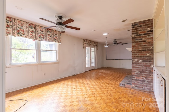 spare room featuring light parquet flooring, plenty of natural light, and ceiling fan