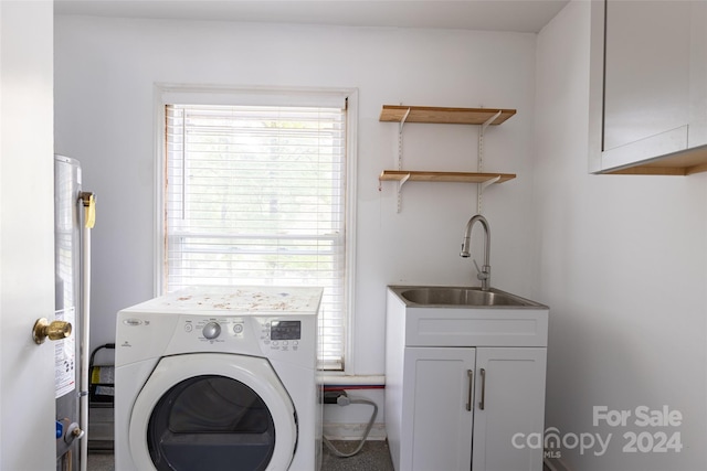 laundry room with washer / dryer, cabinets, and sink