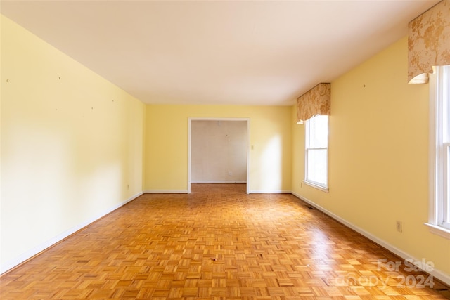 unfurnished room featuring light parquet flooring