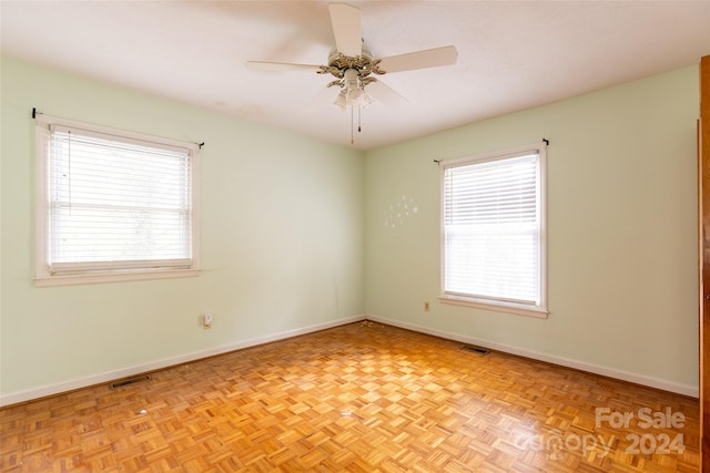 unfurnished room with light parquet floors and ceiling fan