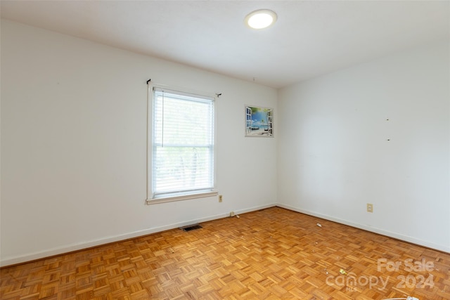 unfurnished room featuring light parquet floors