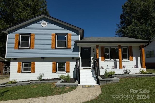 view of front of house featuring a front yard and covered porch