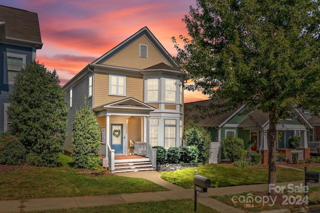 view of front of home with a yard