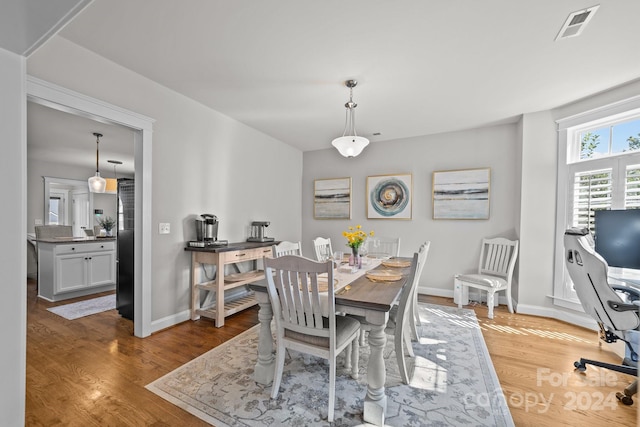 dining area with hardwood / wood-style flooring