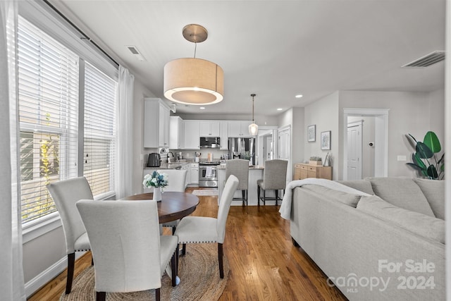 dining space with dark wood-type flooring