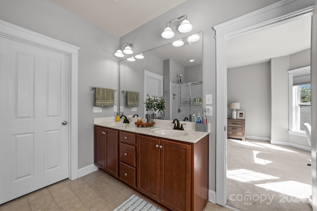 bathroom featuring tile patterned floors, vanity, and a shower with shower door