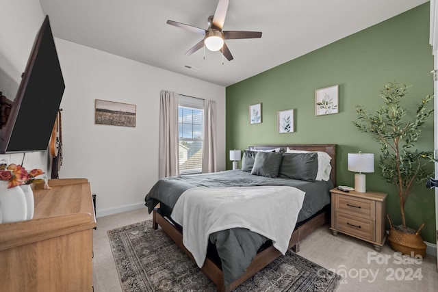 bedroom with light colored carpet and ceiling fan