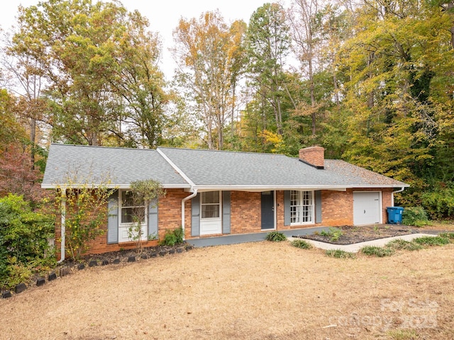 single story home featuring a porch and a garage