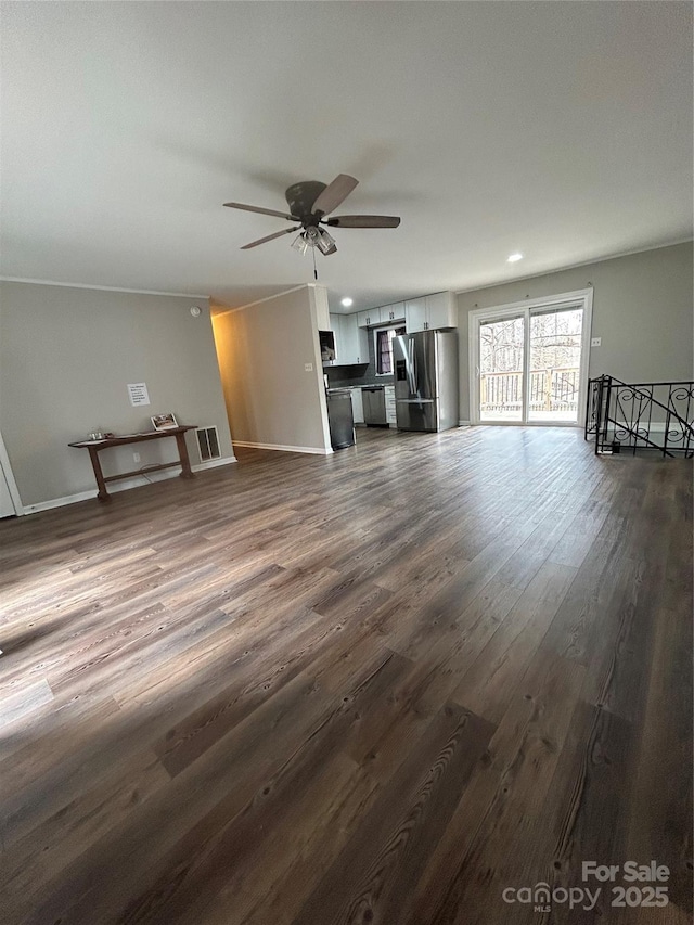 unfurnished living room featuring ceiling fan and dark hardwood / wood-style flooring