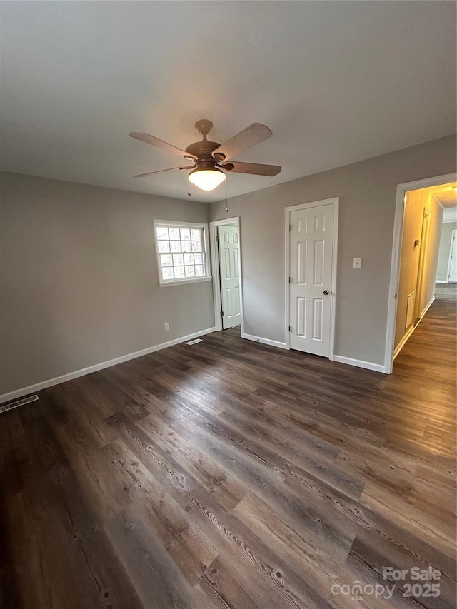 unfurnished room featuring ceiling fan and dark hardwood / wood-style flooring