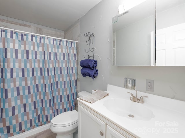 bathroom with vanity, a shower with curtain, and toilet