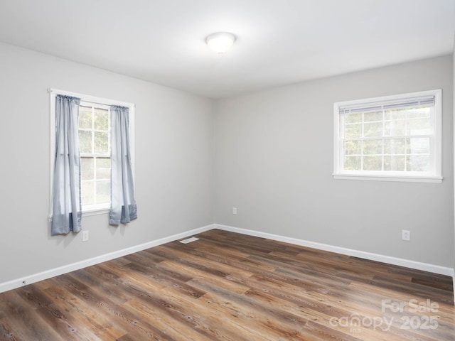 spare room with dark hardwood / wood-style floors