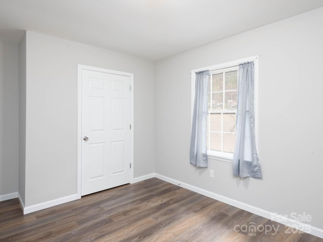 empty room featuring dark wood-type flooring