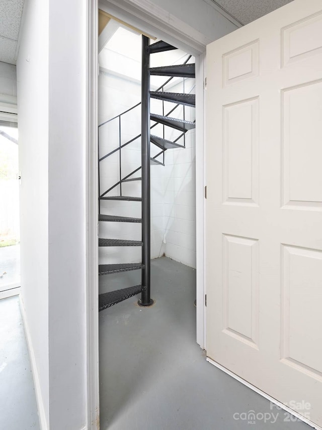 stairs featuring concrete floors