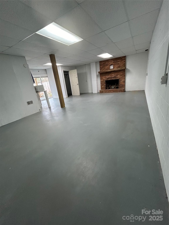 basement featuring a paneled ceiling