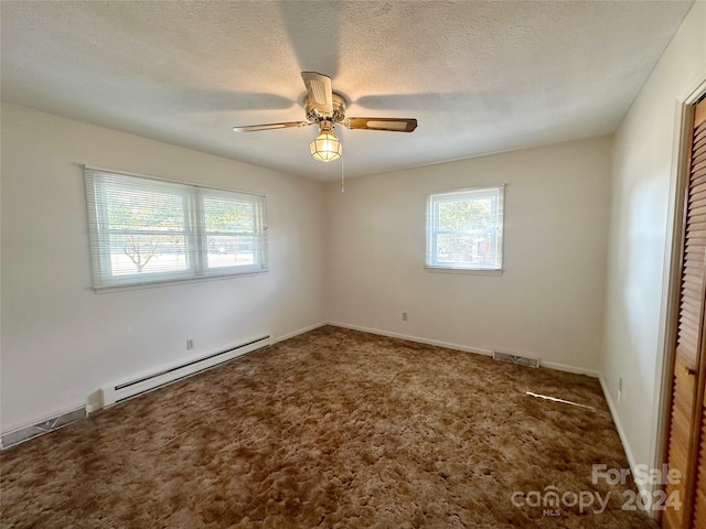 carpeted spare room featuring a textured ceiling, ceiling fan, and a baseboard radiator