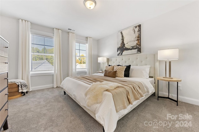 bedroom featuring light carpet