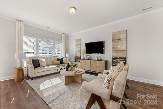504 Kingsway Cir, Charlotte, NC 28214 - living room with ornamental molding, wood finished floors, and baseboards