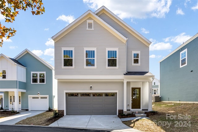 front facade with a garage and central AC unit