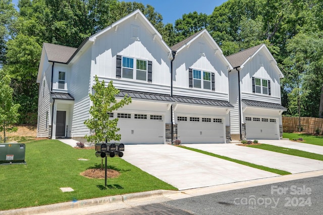 view of front of property with a front yard and a garage