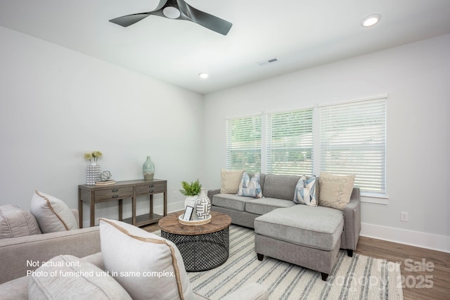 living room with hardwood / wood-style flooring and ceiling fan