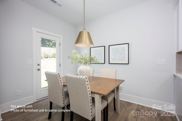 dining room with dark hardwood / wood-style flooring