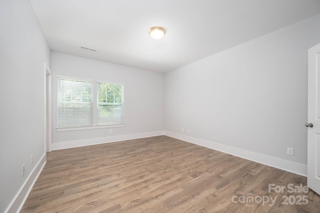 unfurnished room featuring wood-type flooring