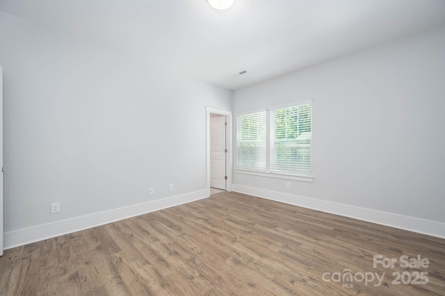 spare room featuring hardwood / wood-style flooring